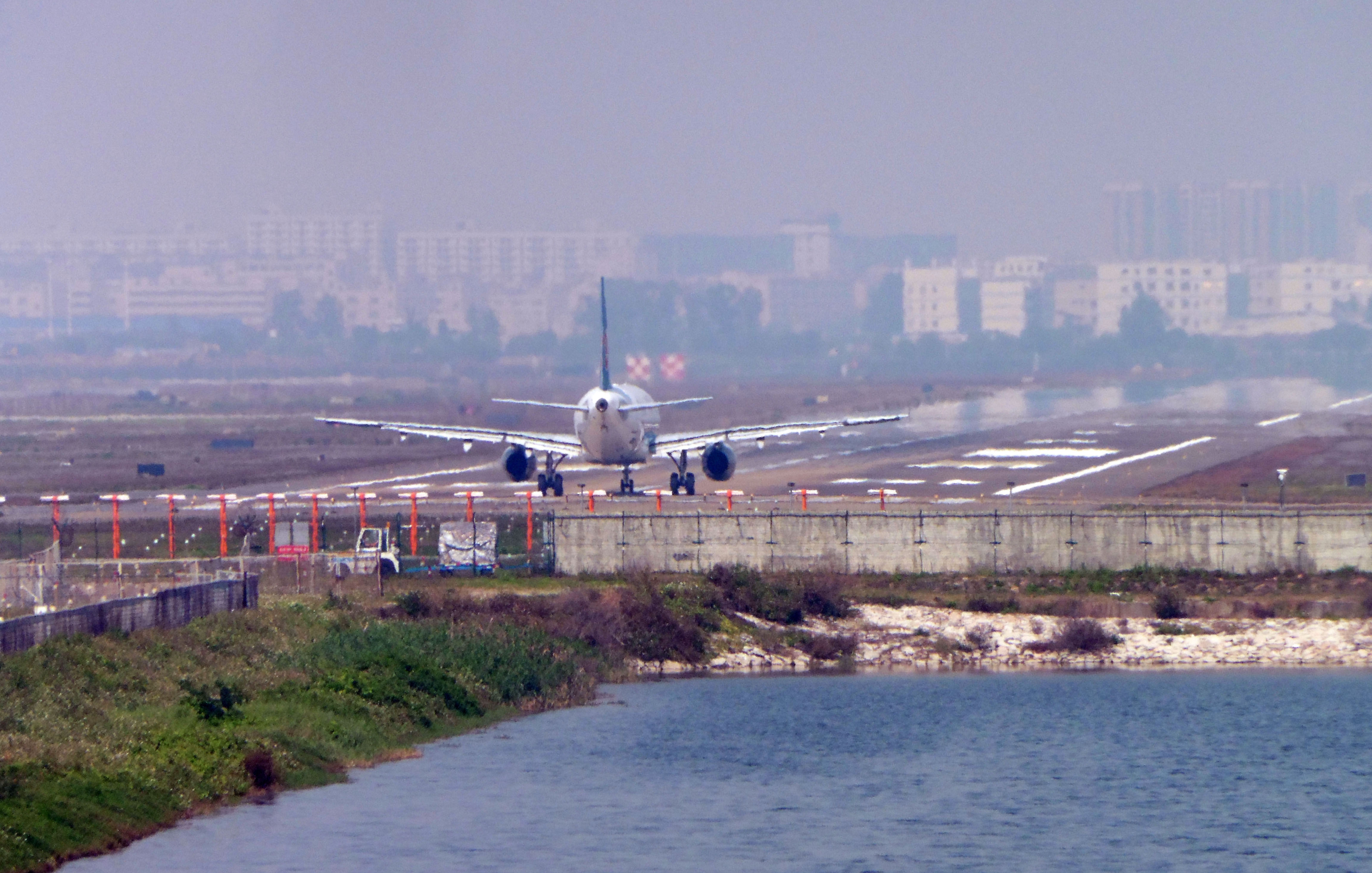 A plane lands at Shenzhen International Airport in China. CREDIT: Chris/Flickr