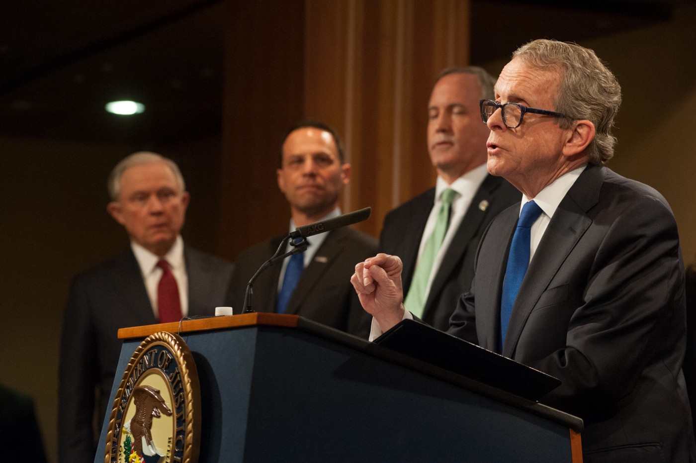 Gov. Mike DeWine, far right, then the state’s attorney general, delivers remarks at the Justice Department in 2018. CREDIT: DOJ