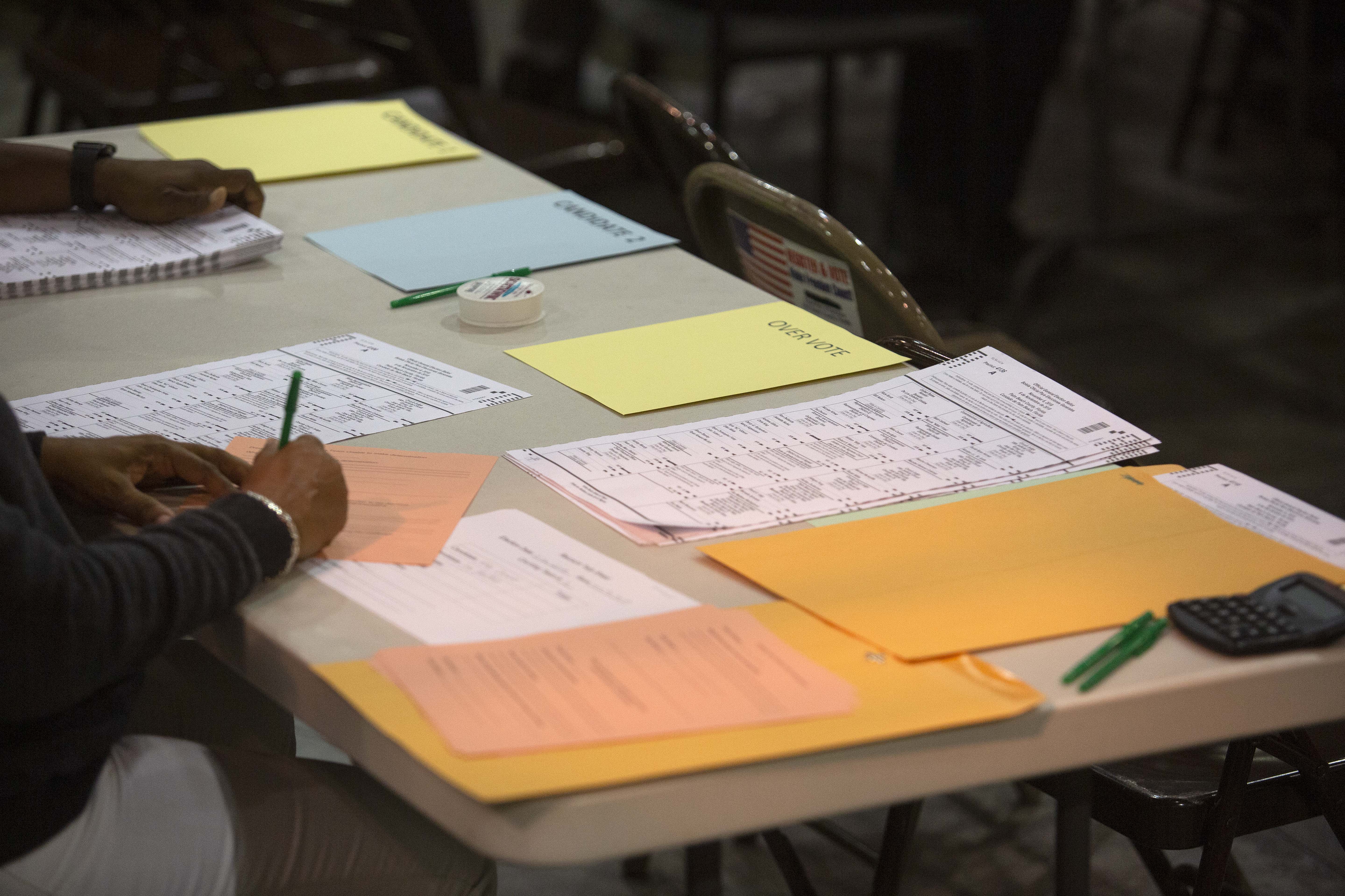 PALM BEACH, FL - NOVEMBER 18: Volunteers look at ballots during a hand recount at the Supervisor of Elections Service Center on November 18, 2018 in Palm Beach, Florida. (Photo by Saul Martinez/Getty Images)