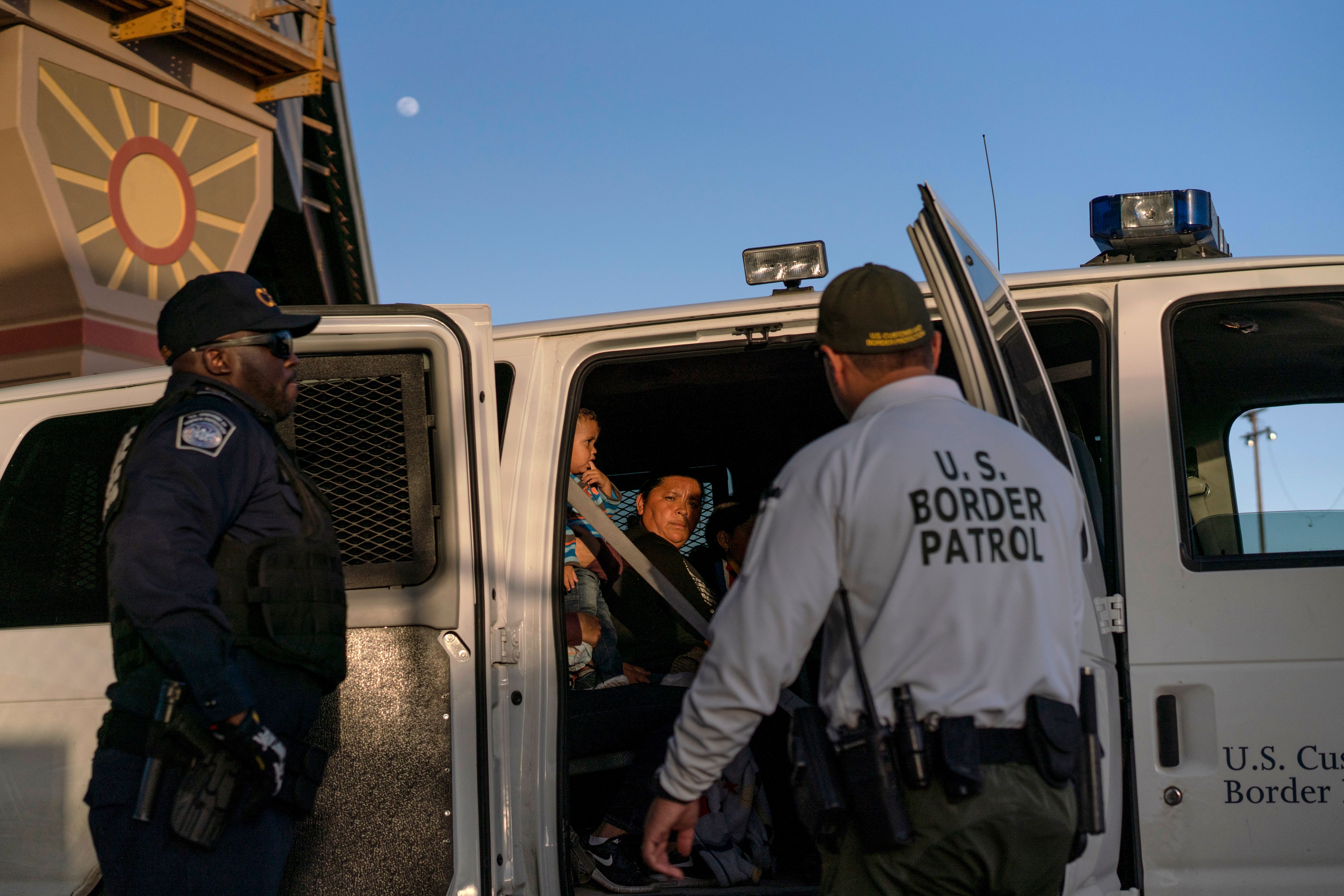 Migrants, mostly from Central America, board a van which will take them to a processing center, on May 16, 2019, in El Paso, Texas. A new report from the Department of Homeland Security's Office of Inspector General notes that poor conditions at a border station in El Paso, Texas, observed on a May 7 tour, can be used to deter migrants from entering the United States. (Photo credit: PAUL RATJE/AFP/Getty Images)