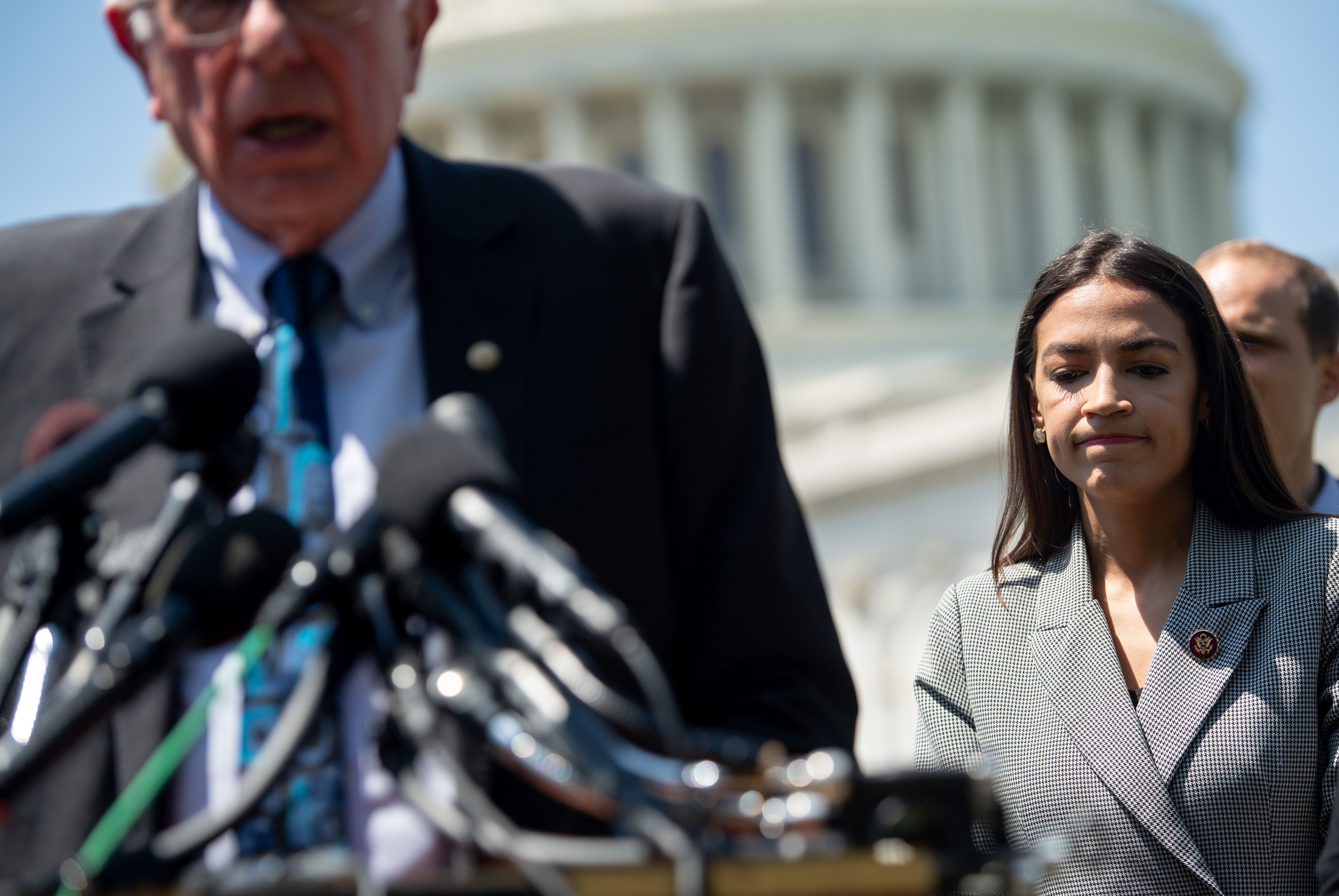 US Senator Bernie Sanders (L), Independent of Vermont, speaks alongside Representative Alexandria Ocasio-Cortez (R), Democrat of New York, during a press conference. CREDIT: SAUL LOEB/AFP/Getty Images