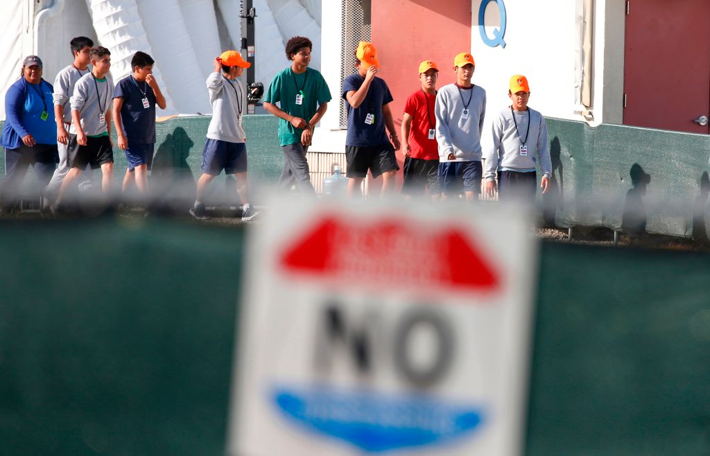 Migrant children who have been separated from their families walk at a detention center in Homestead, Florida. A pastor told Fox News that the facility provides "phenomenal" care.