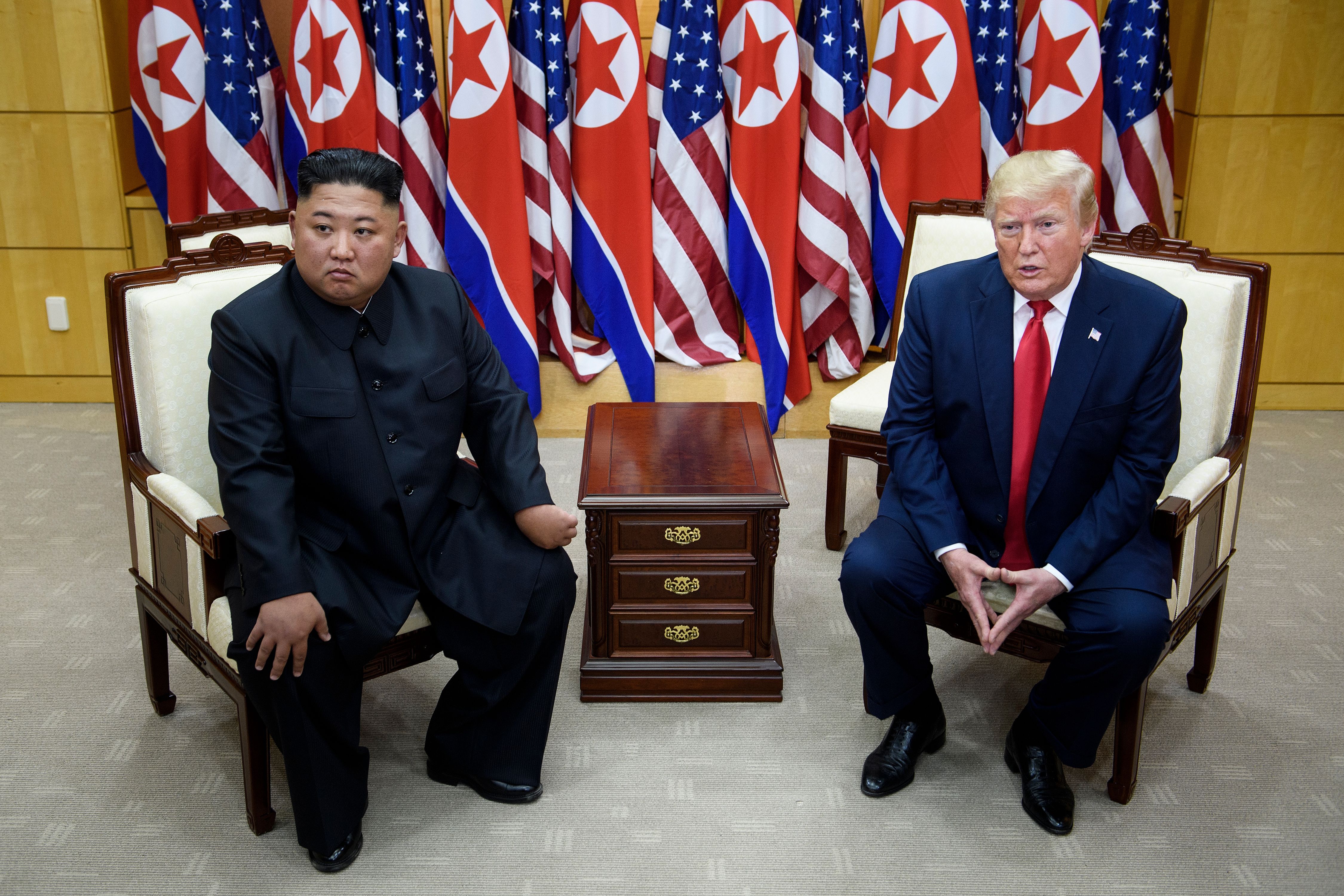 North Korea's leader Kim Jong-un and President Donald Trump meet on the south side of the Military Demarcation Line that divides North and South Korea on June 30, 2019. CREDIT: Brendan Smialowski/AFP/Getty Images.