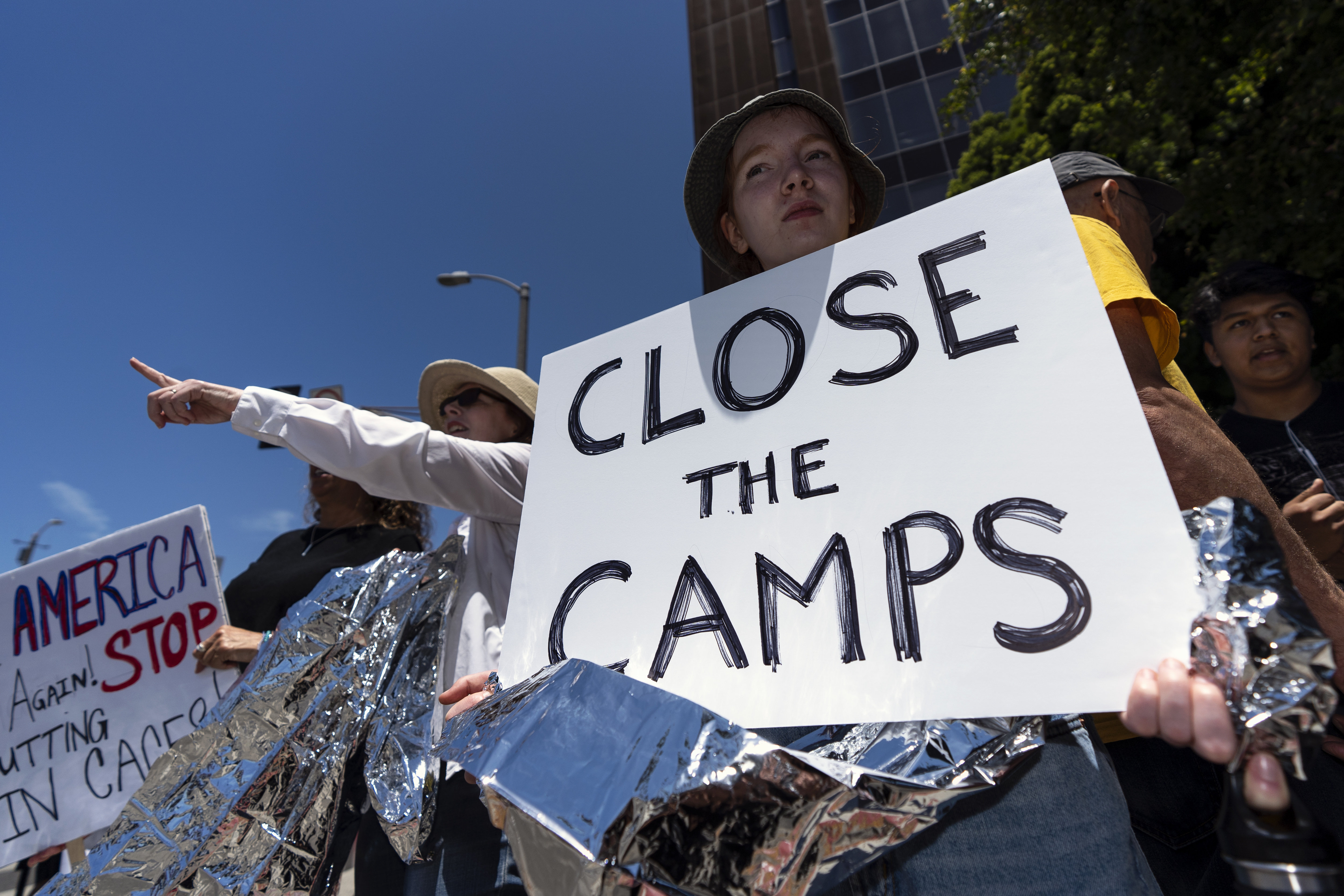 Protesters hold up placards as they participate in a Close The Camps protest against migrant detention centers. (Credit: Ronen Tivony/SOPA Images/LightRocket via Getty Images)