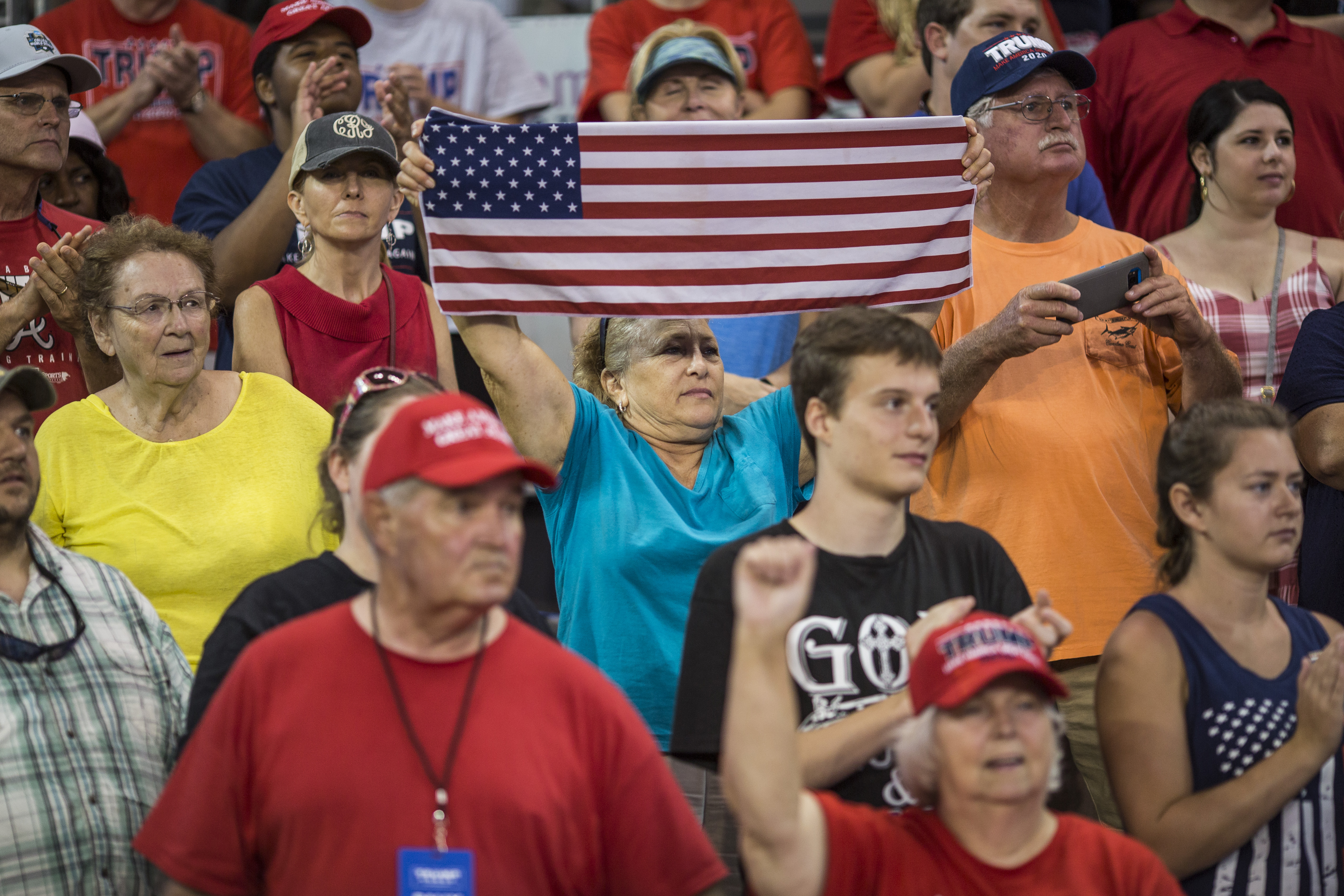 The nation will be better and live up to its lofty ambitions, only when white supporters of President Trump, such as these waiting Wednesday in Greenville, N.C., reject the president's racism. (Photo by Zach Gibson/Getty Images)