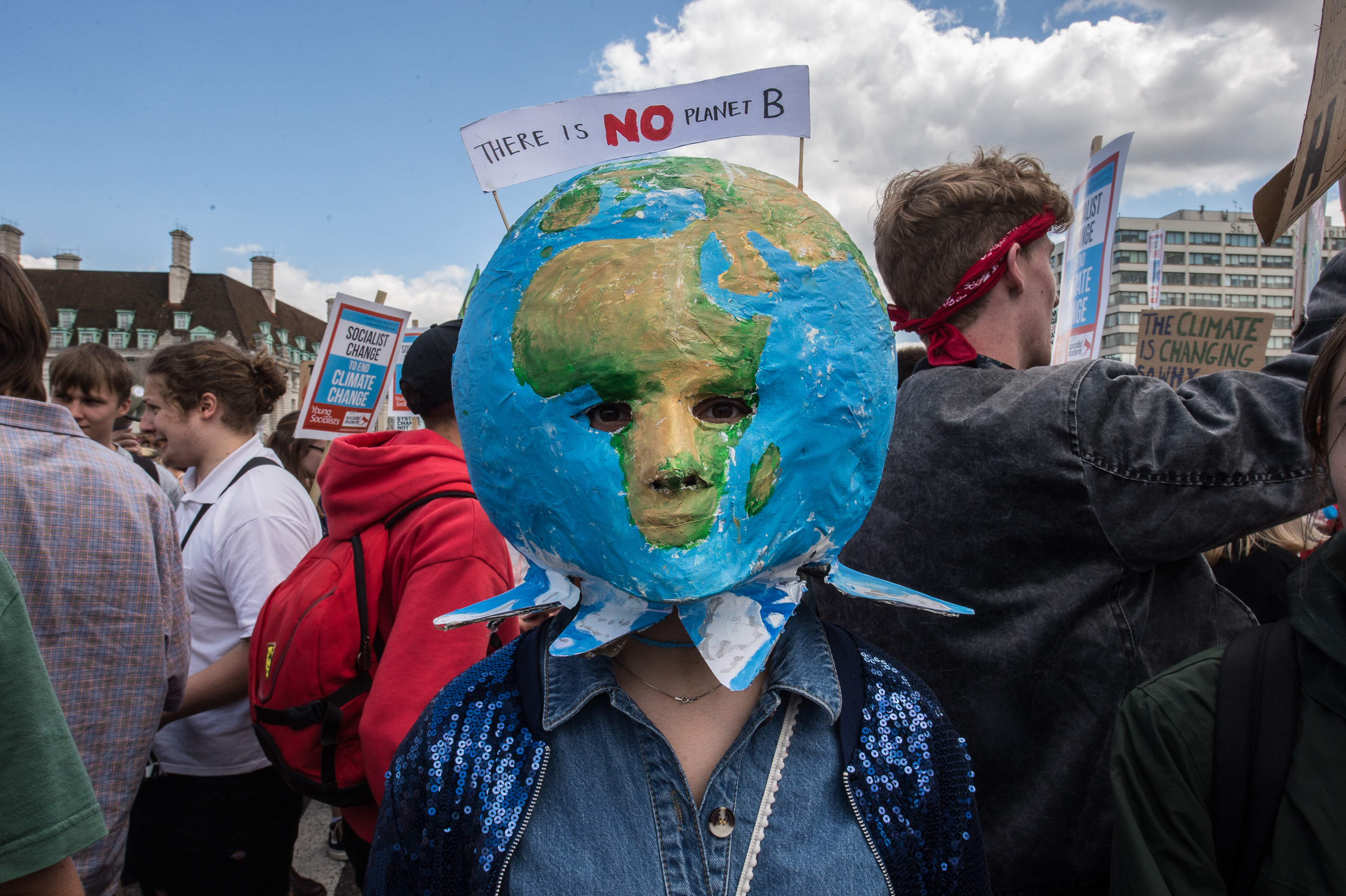 A striking school student with a planet mask on Westminster bridge on June 21, 2019. CREDIT: Guy Smallman/Getty Images