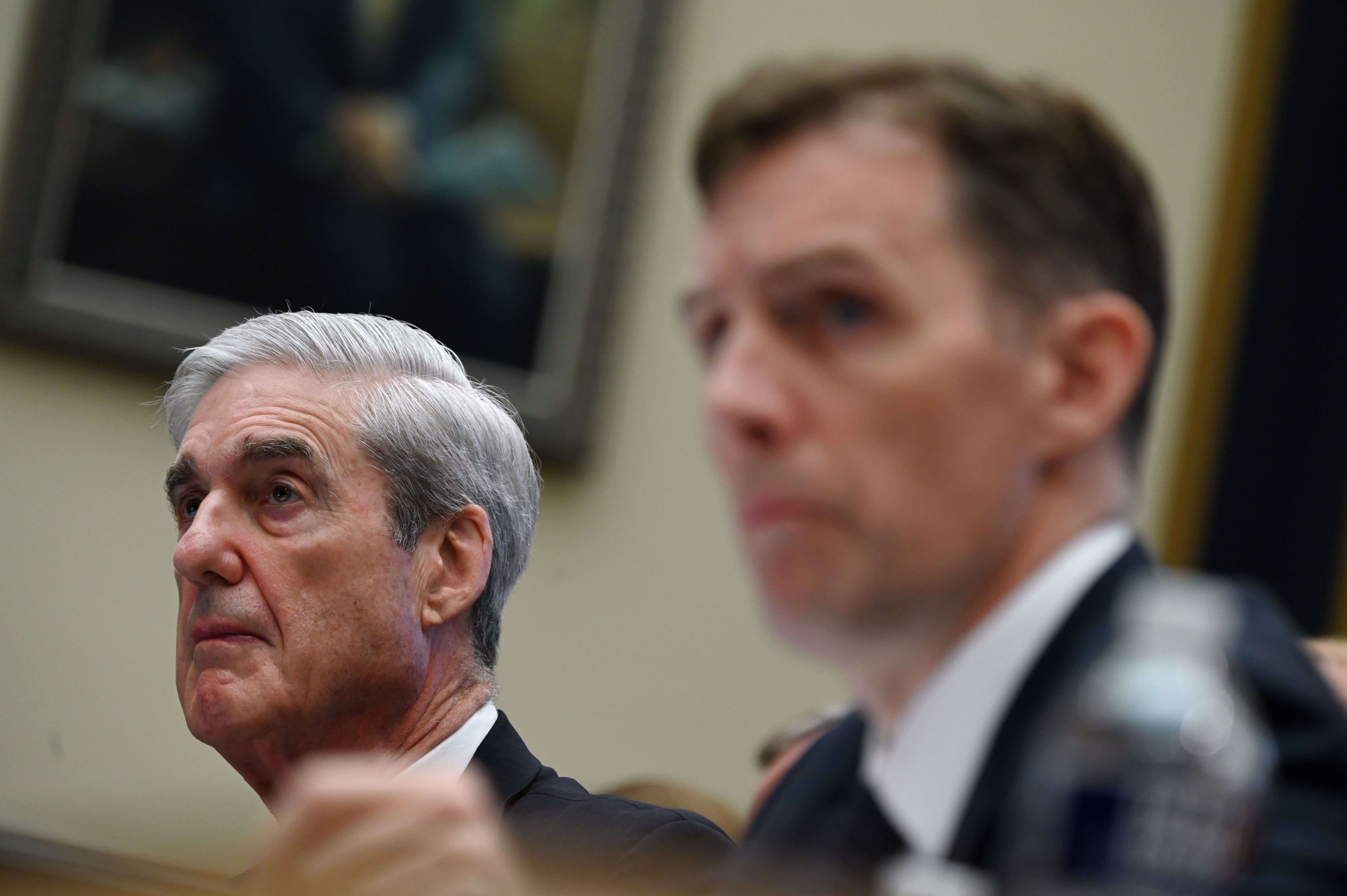 Former special counsel Robert Mueller, left, with former deputy special counsel Aaron Zebley, listens during a hearing before Congress on July 24, 2019, in Washington, D.C. CREDIT: ANDREW CABALLERO-REYNOLDS/AFP/Getty Images