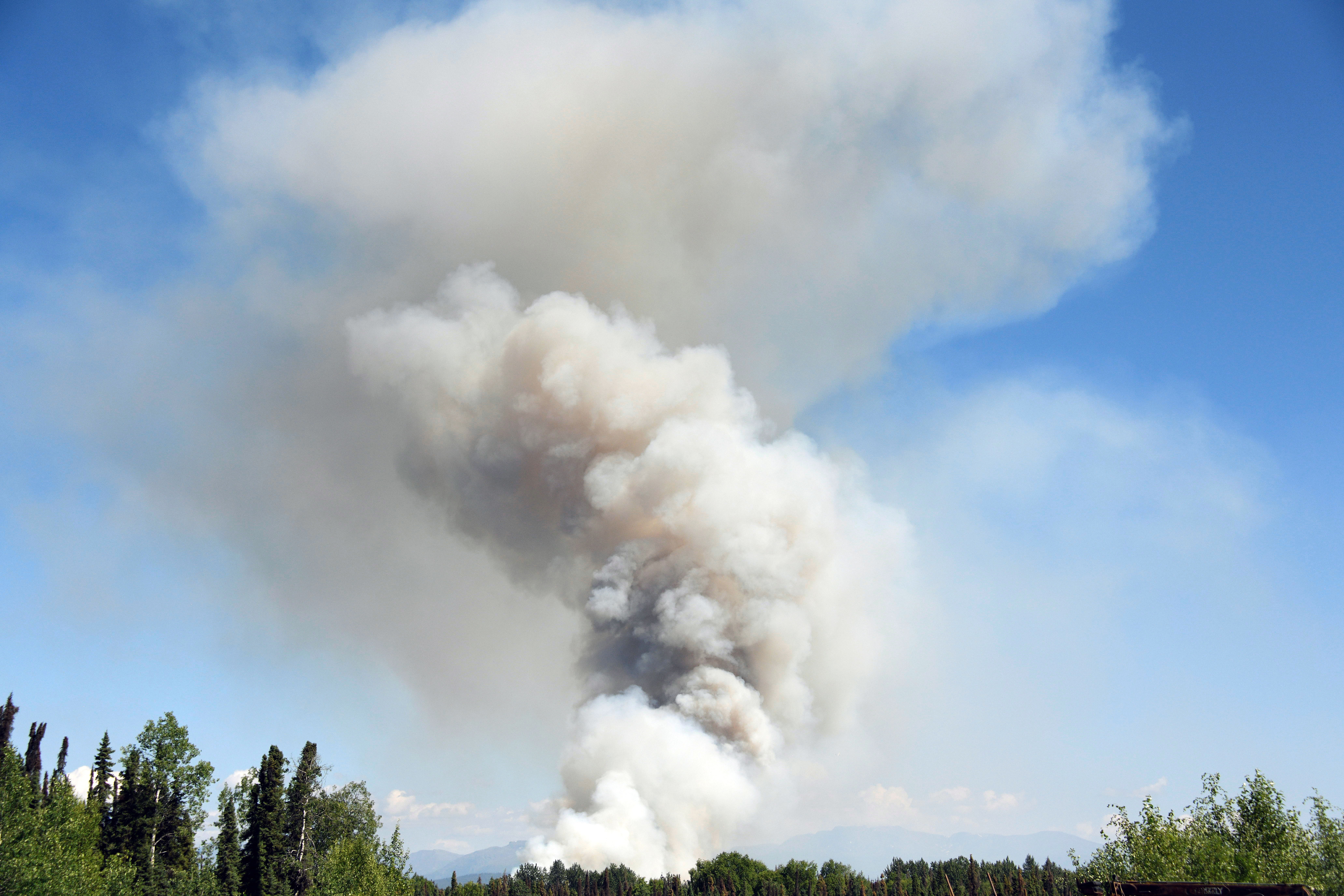 Smoke rises from a wildfire on July 3, 2019 south of Talkeetna, Alaska near the George Parks Highway. CREDIT: Lance King/Getty Images