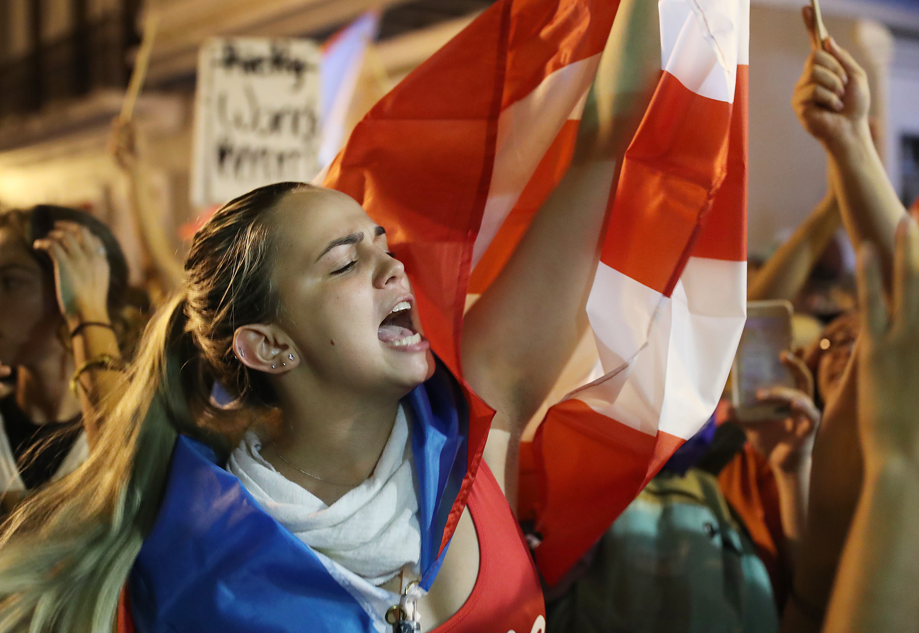 SAN JUAN, PUERTO RICO - JULY 23: People react after hearing, while demonstrating near the governor's mansion, reports that Gov. Ricardo Rossello will step down, on July 23, 2019 in Old San Juan, Puerto Rico. Protesters have been calling on Rosselló to resign after a group chat was exposed that included misogynistic and homophobic comments allegedly made between the governor and top aides. (Photo by Joe Raedle/Getty Images)