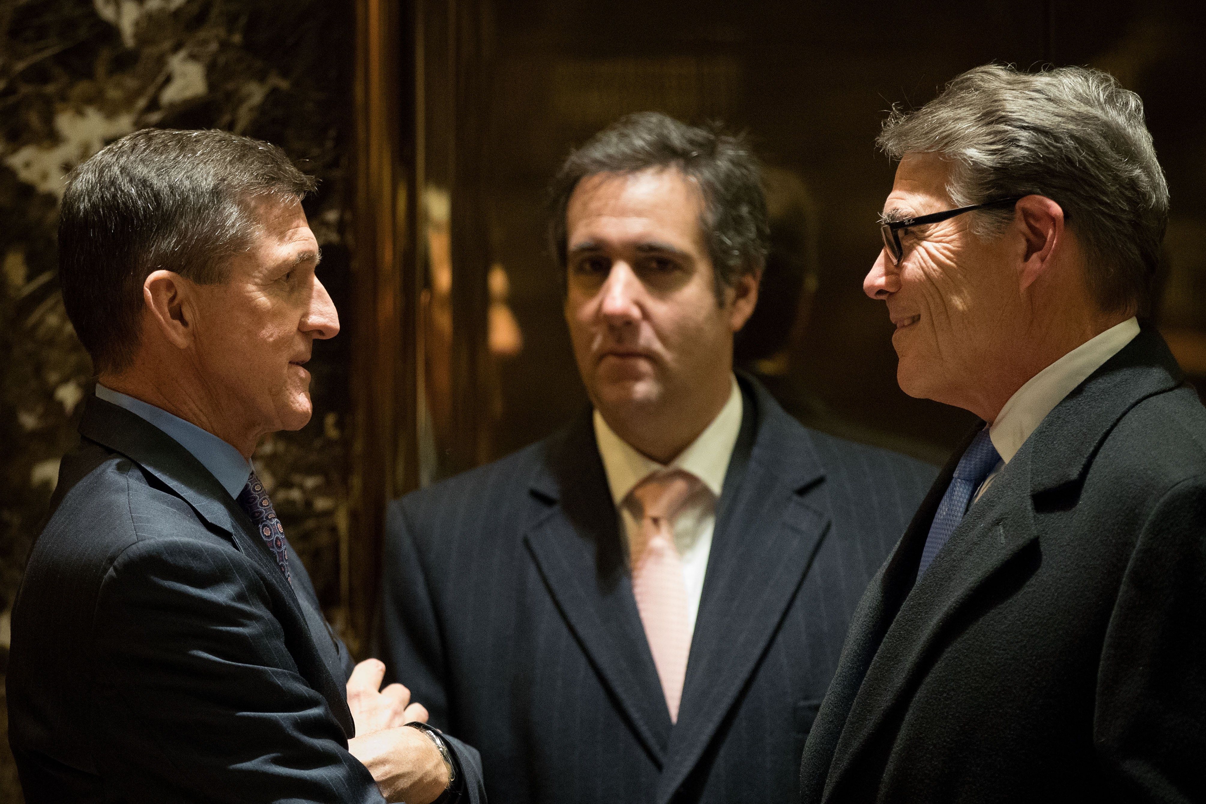 Michael Flynn, Michael Cohen, and Rick Perry talk in the lobby of Trump Tower on Dec. 12, 2016 in New York City. CREDIT: Drew Angerer/Getty Images