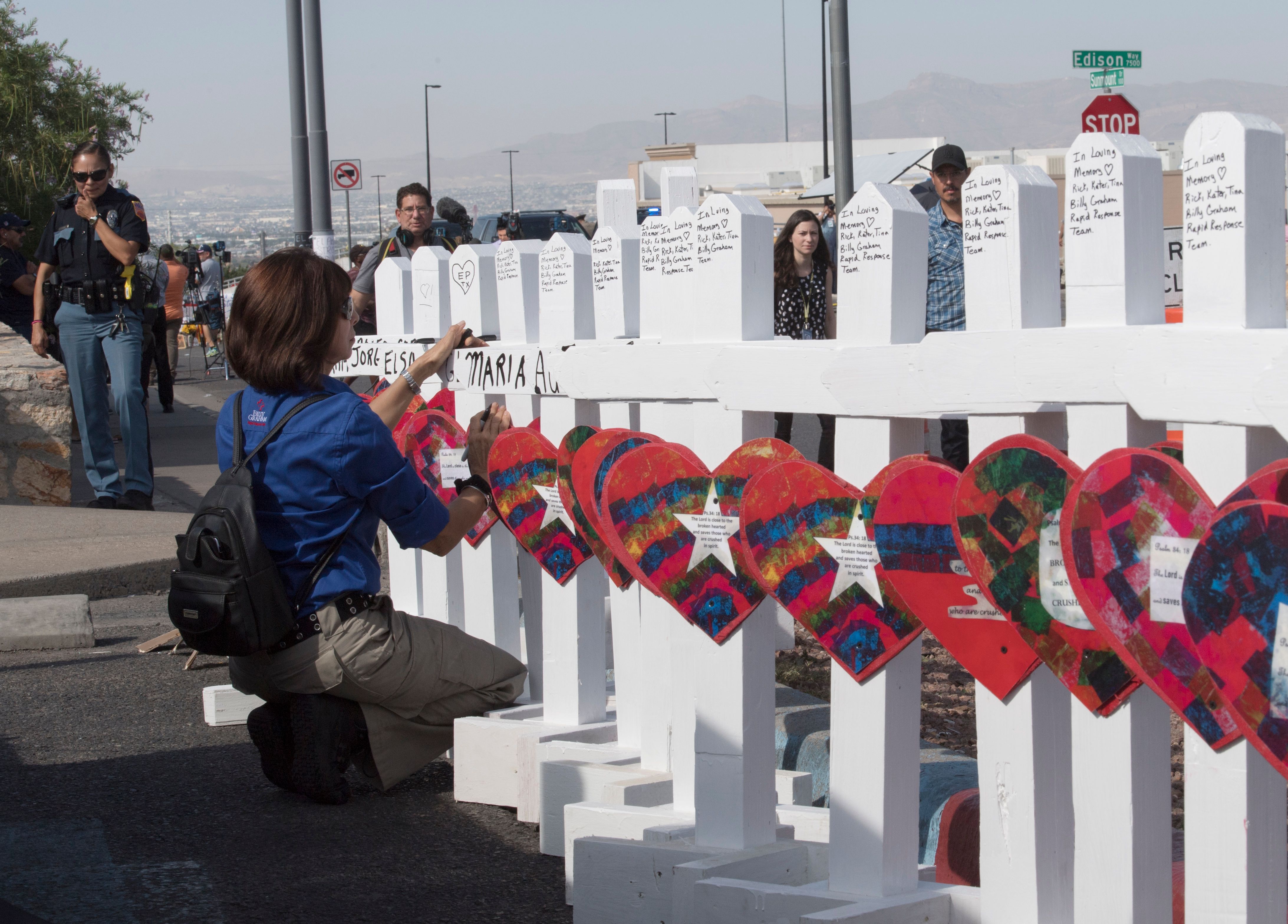 Members of the 'Crosses for Losses' group arrive at the scene with crosses for each victim, after the shooting that left 21 people dead at the Cielo Vista Mall WalMart in El Paso, Texas, on August 5, 2019. - US President Donald Trump on Monday urged Republicans and Democrats to agree on tighter gun control and suggested legislation could be linked to immigration reform after two shootings left 30 people dead and sparked accusations that his rhetoric was part of the problem. "Republicans and Democrats must come together and get strong background checks, perhaps marrying this legislation with desperately needed immigration reform," Trump tweeted as he prepared to address the nation on two weekend shootings in Texas and Ohio. "We must have something good, if not GREAT, come out of these two tragic events!" Trump wrote. (Photo by Mark RALSTON / AFP) (Photo credit should read MARK RALSTON/AFP/Getty Images)