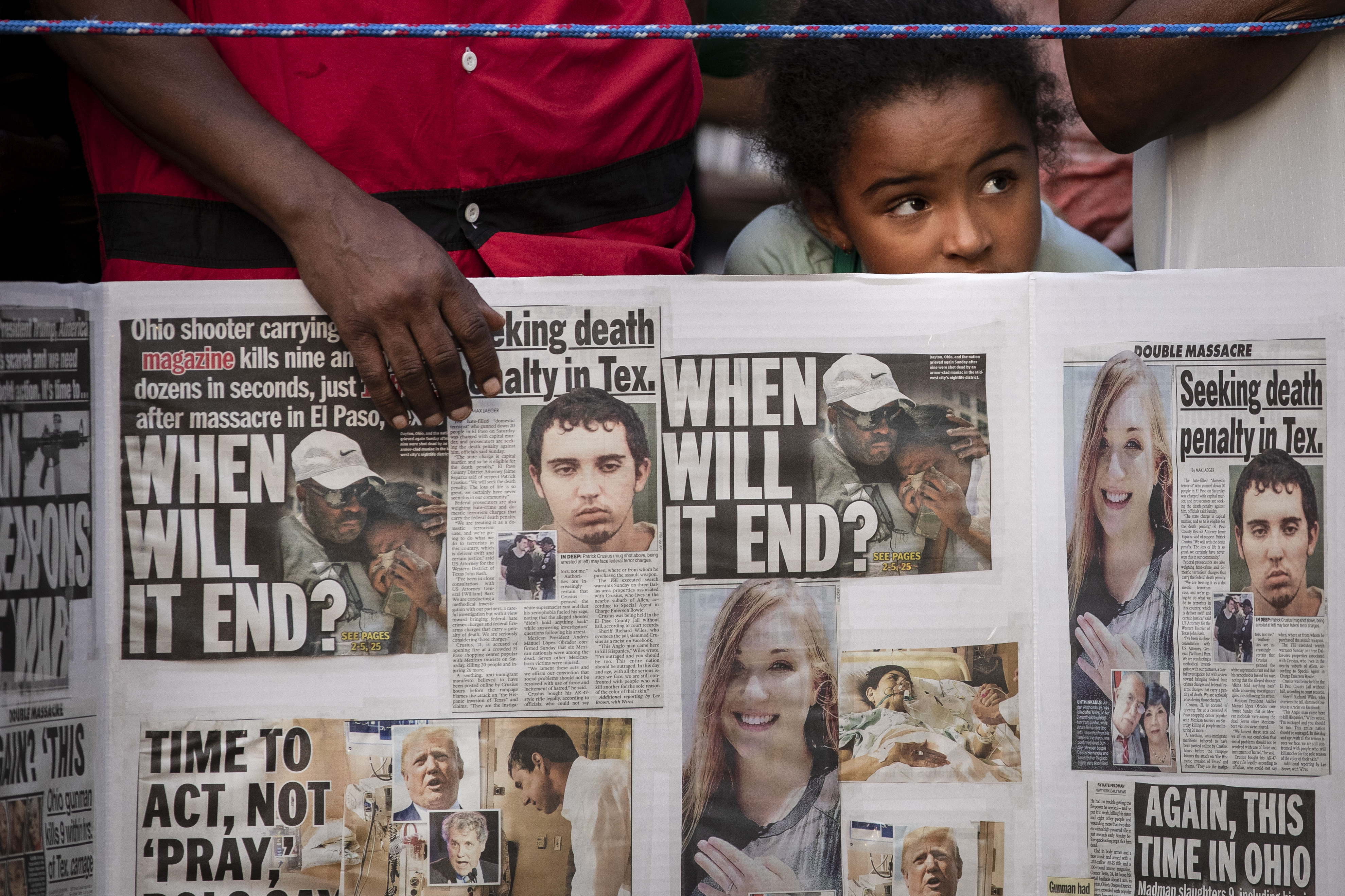 NEW YORK, NY - AUGUST 5: A young girl looks on as she attends a vigil for the victims of the recent mass shootings in El Paso, Texas and Dayton, Ohio, in Grand Army Plaza on August 5, 2019. (Photo by Drew Angerer/Getty Images)