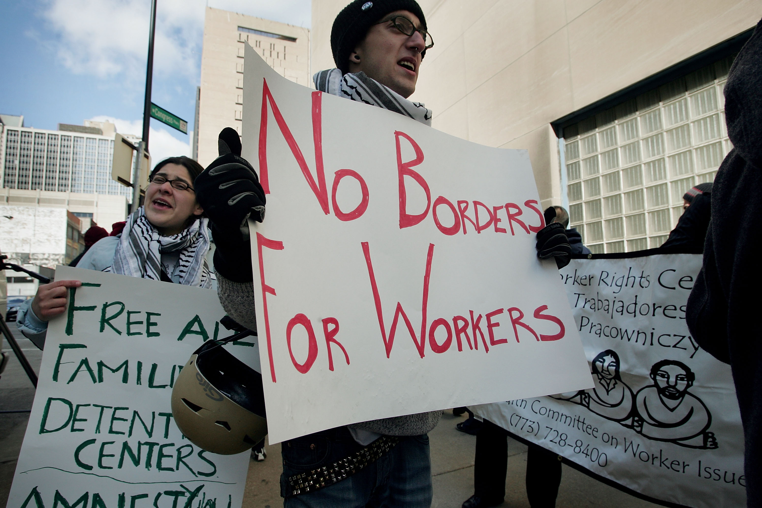 Demonstrators protest outside an Illinois plant ICE raided in April. (Photo credit: Scott Olson/Getty Images)