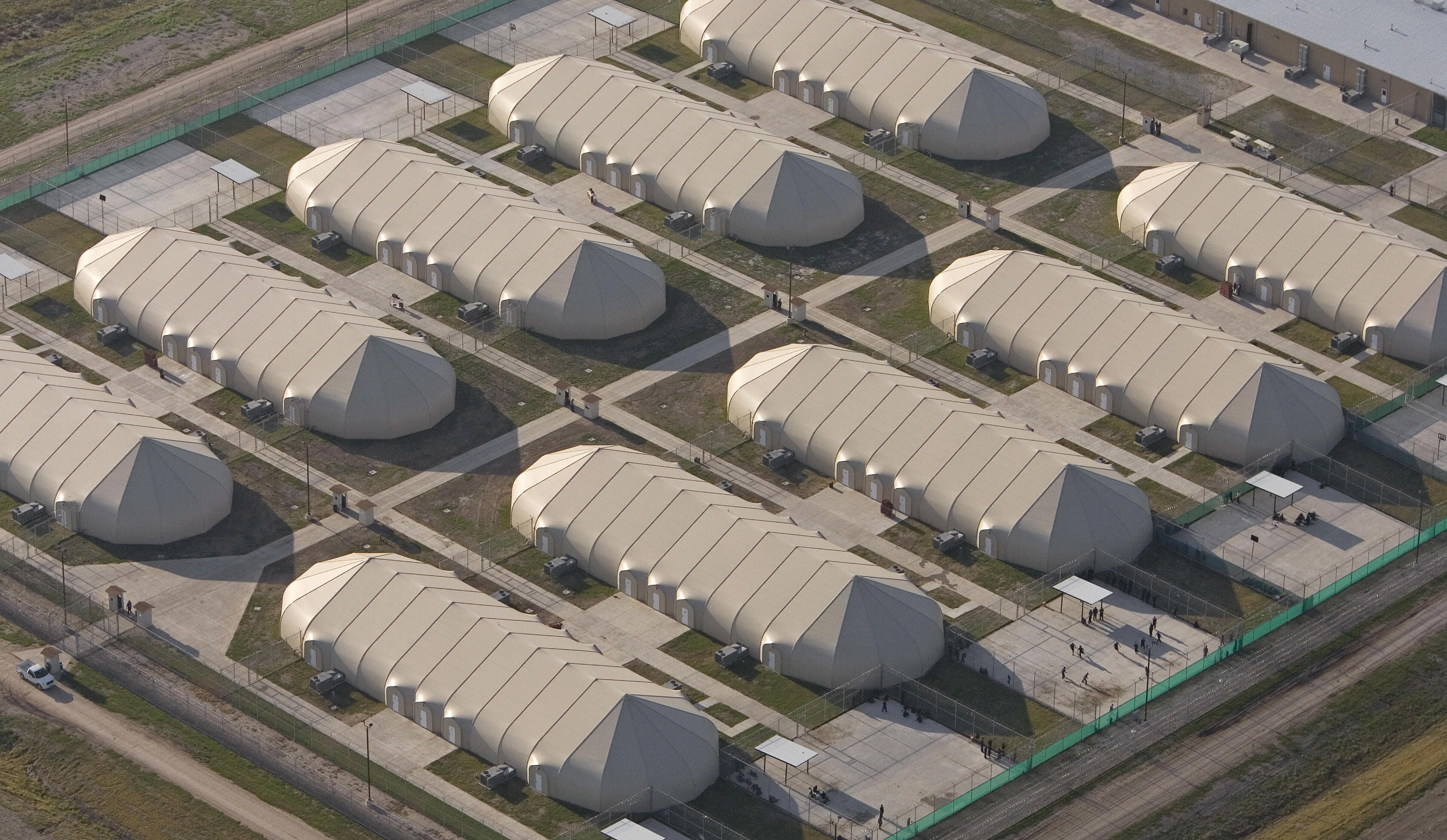 Raymondville, UNITED STATES: A futuristic USD 65 million tent city designed to hold about 2,000 illegal immigrants is pictured 10 April 2006 in Raymondville, Texas. The newly-constructed barbed-wire enclosed camp in the Rio Grande Valley will hold illegal immigrants for weeks to years until they can be returned to their home countires by US officials. AFP Photo/Paul J. Richards (Photo credit should read PAUL J. RICHARDS/AFP/Getty Images)