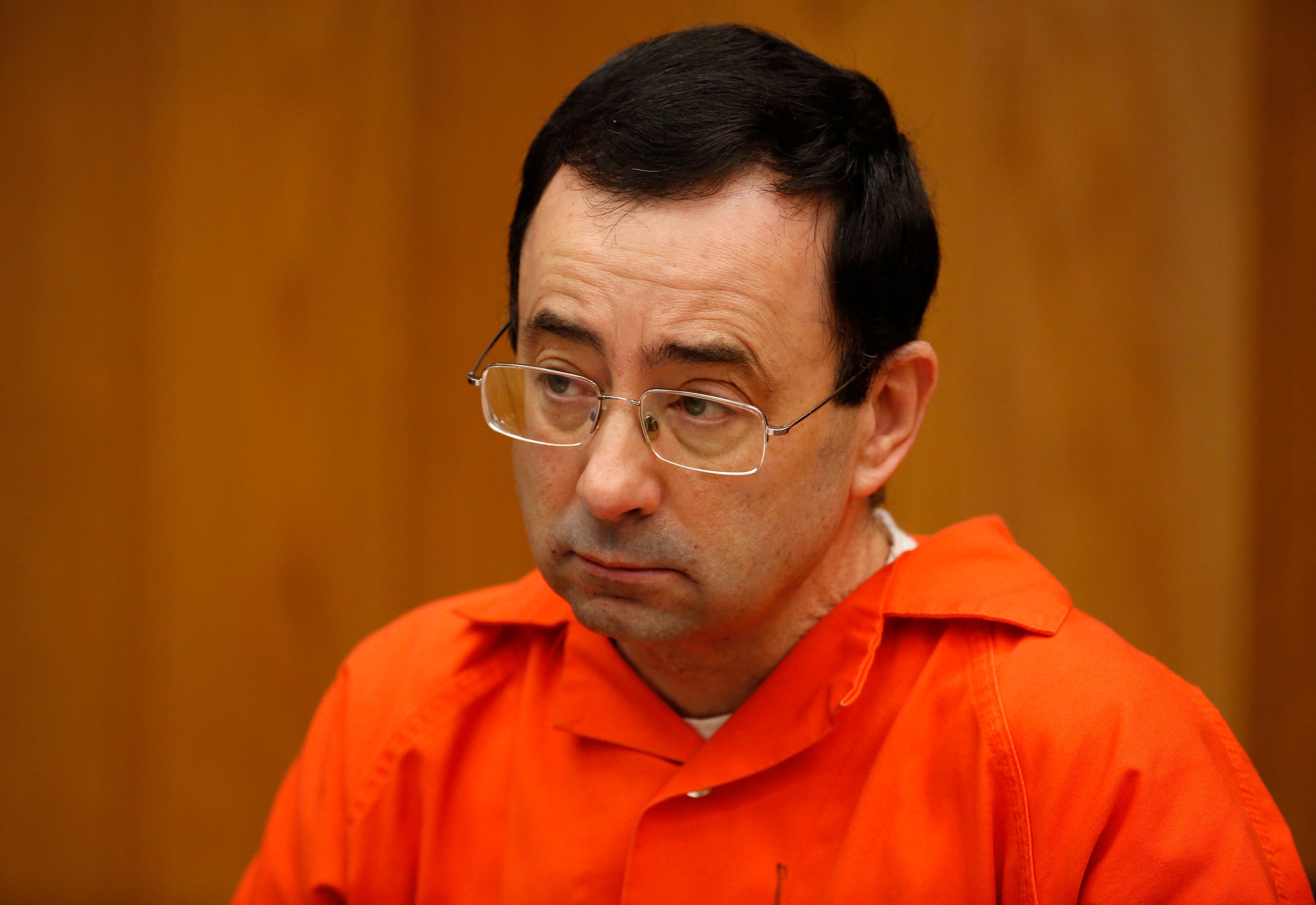Former Michigan State University and USA Gymnastics doctor Larry Nassar listens during the sentencing phase in Eaton, County Circuit Court on January 31, 2018 in Charlotte, Michigan.
(Photo credit: JEFF KOWALSKY/AFP/Getty Images)